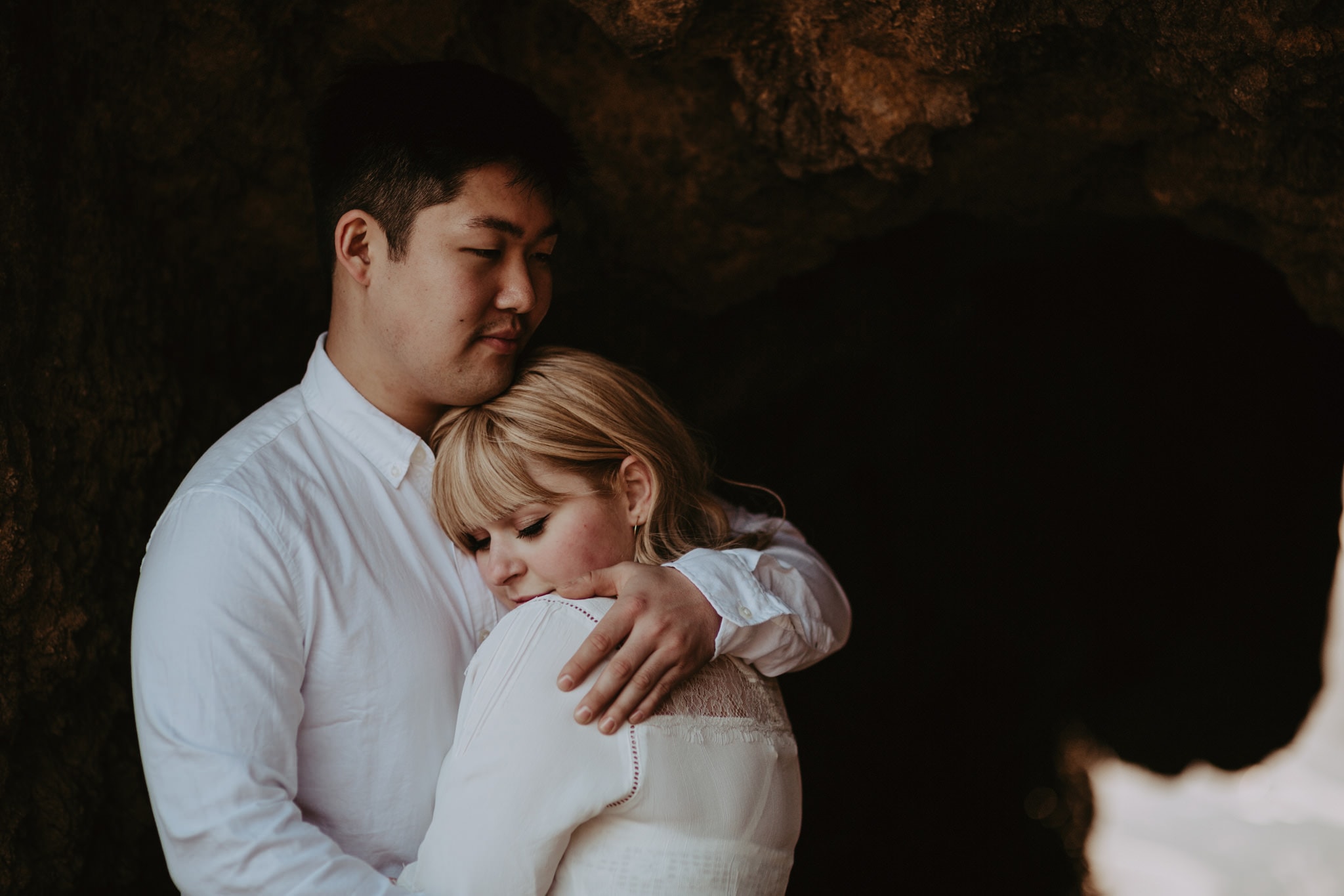 oceanside cuddles in a cave El Matador Beach Engagement Marcela Pulido Portland Wedding Photographer