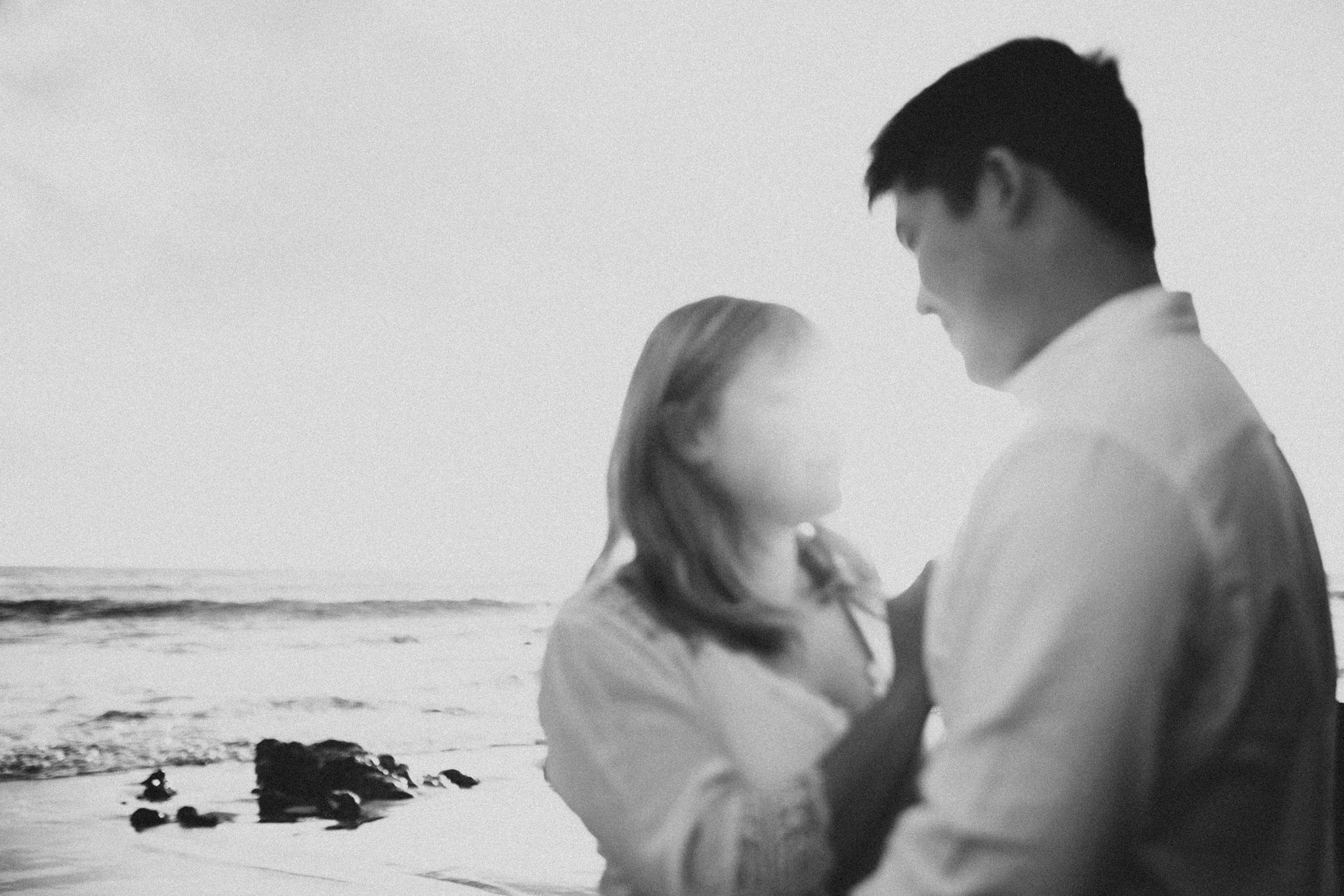 black and white blurry movement shot El Matador Beach Engagement Marcela Pulido Portland Wedding Photographer