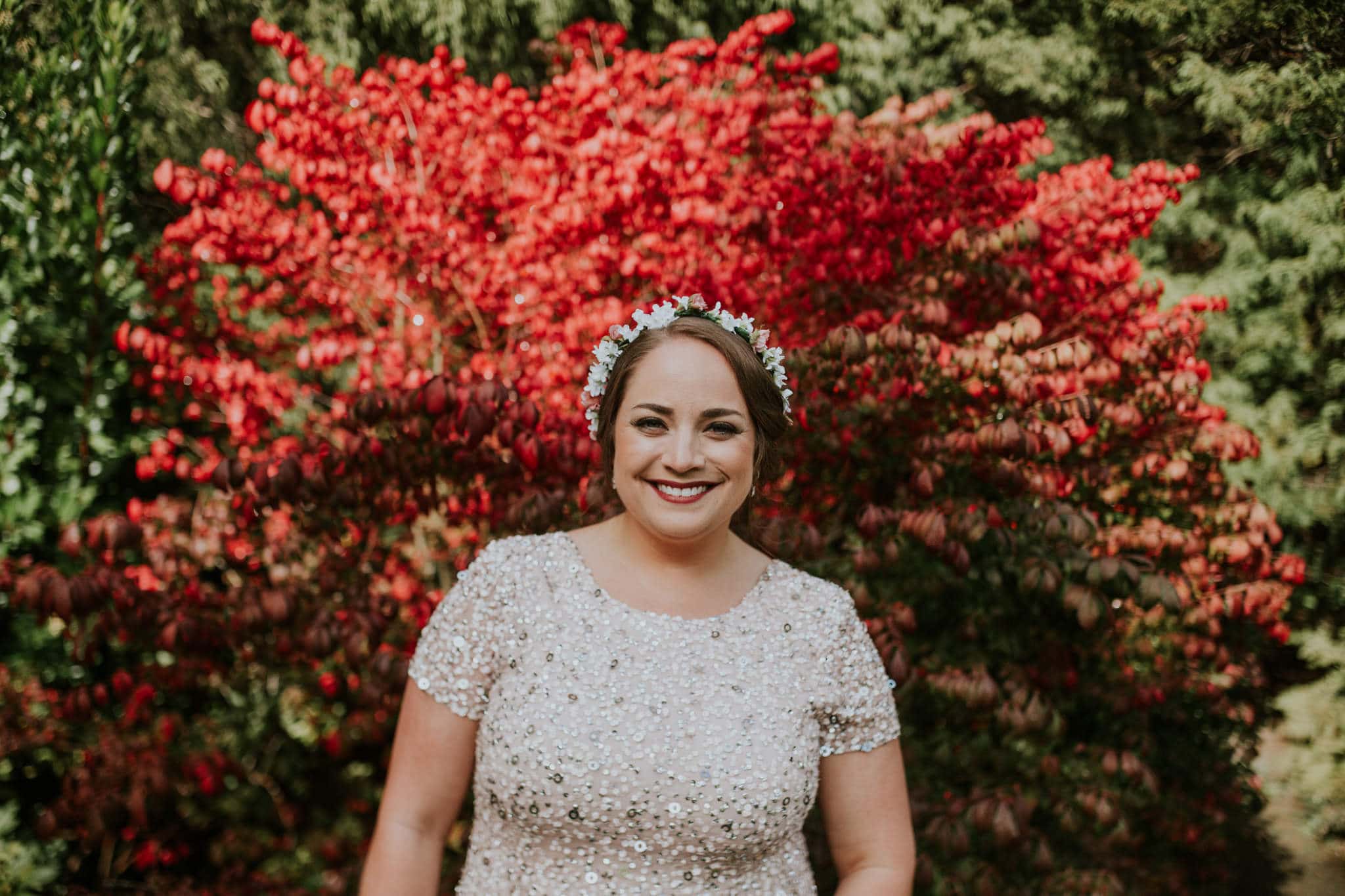 beautiful bride portrait in front of red bush Kubota Garden Wedding by Marcela Pulido Photography Portland Wedding Photographer