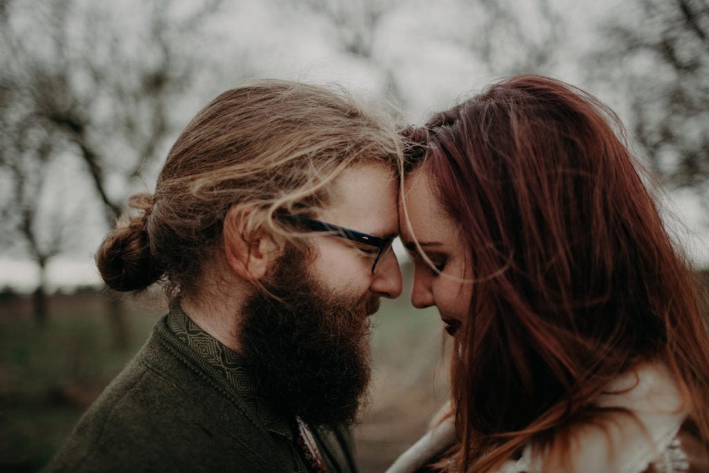 cute boho hippie couple touching foreheads Powell Butte Portland Engagement Photographer by Marcela Pulido Photography Portland Wedding Photographer