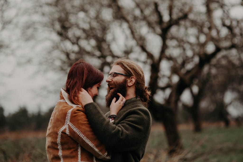 hippie couple laughing in forest Powell Butte Portland Engagement Photographer by Marcela Pulido Photography Portland Wedding Photographer