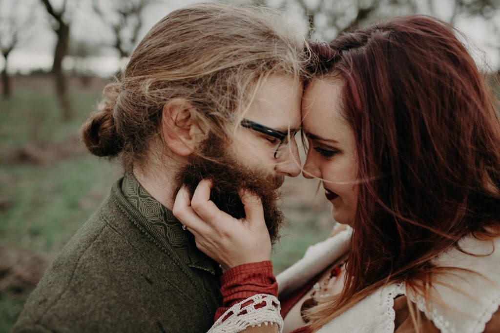 hippie couple intimate close up girl's hand in guy's beard Powell Butte Portland Engagement Photographer by Marcela Pulido Photography Portland Wedding Photographer