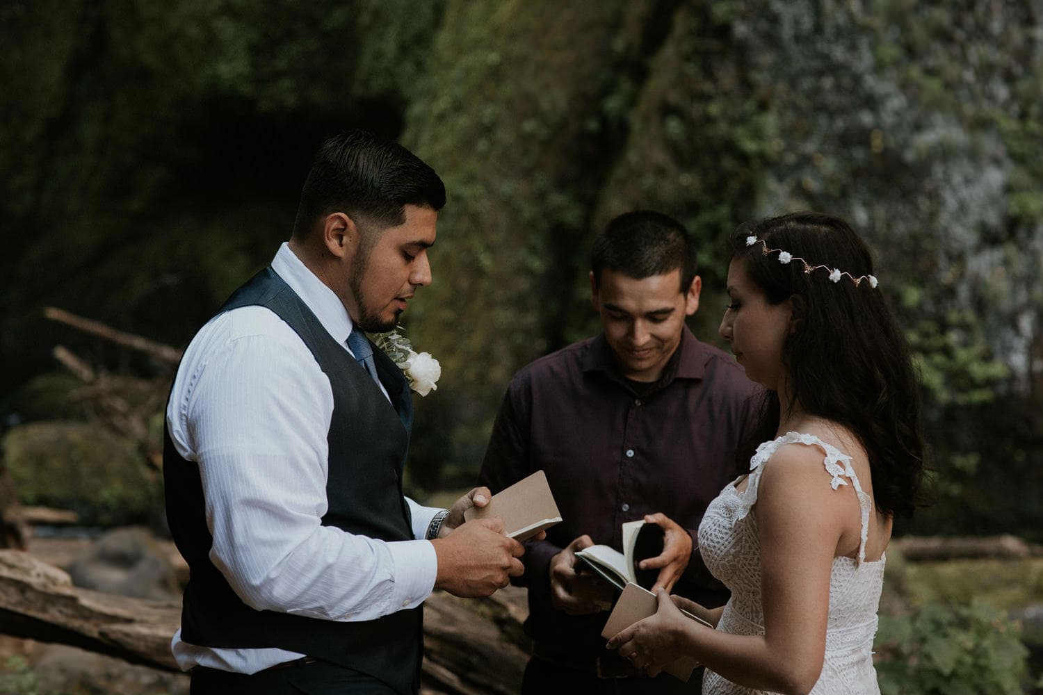 reading their vows in front of Wahclella Falls Oregon Columbia River Gorge elopement