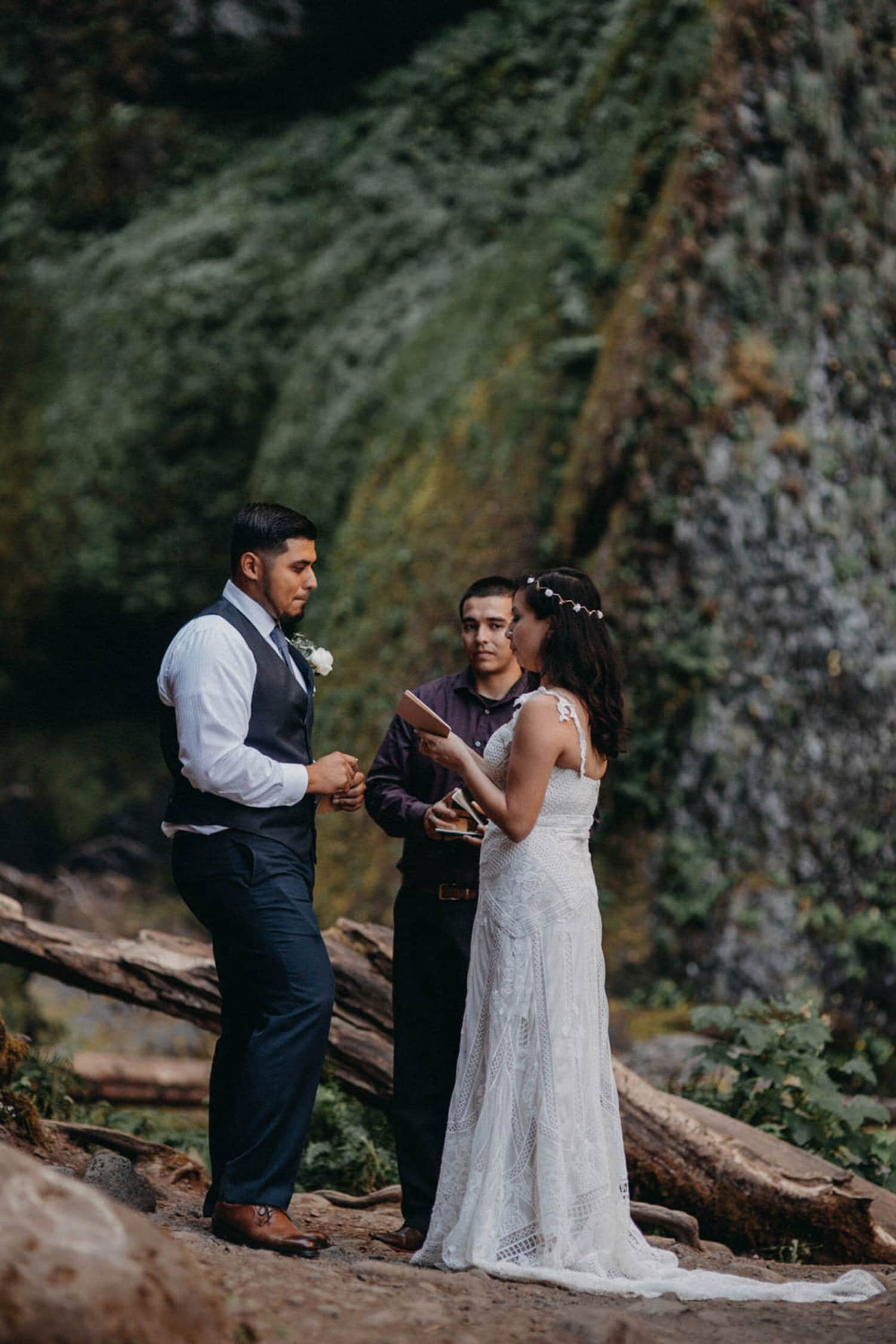 reading their vows in front of Wahclella Falls Oregon Columbia River Gorge elopement