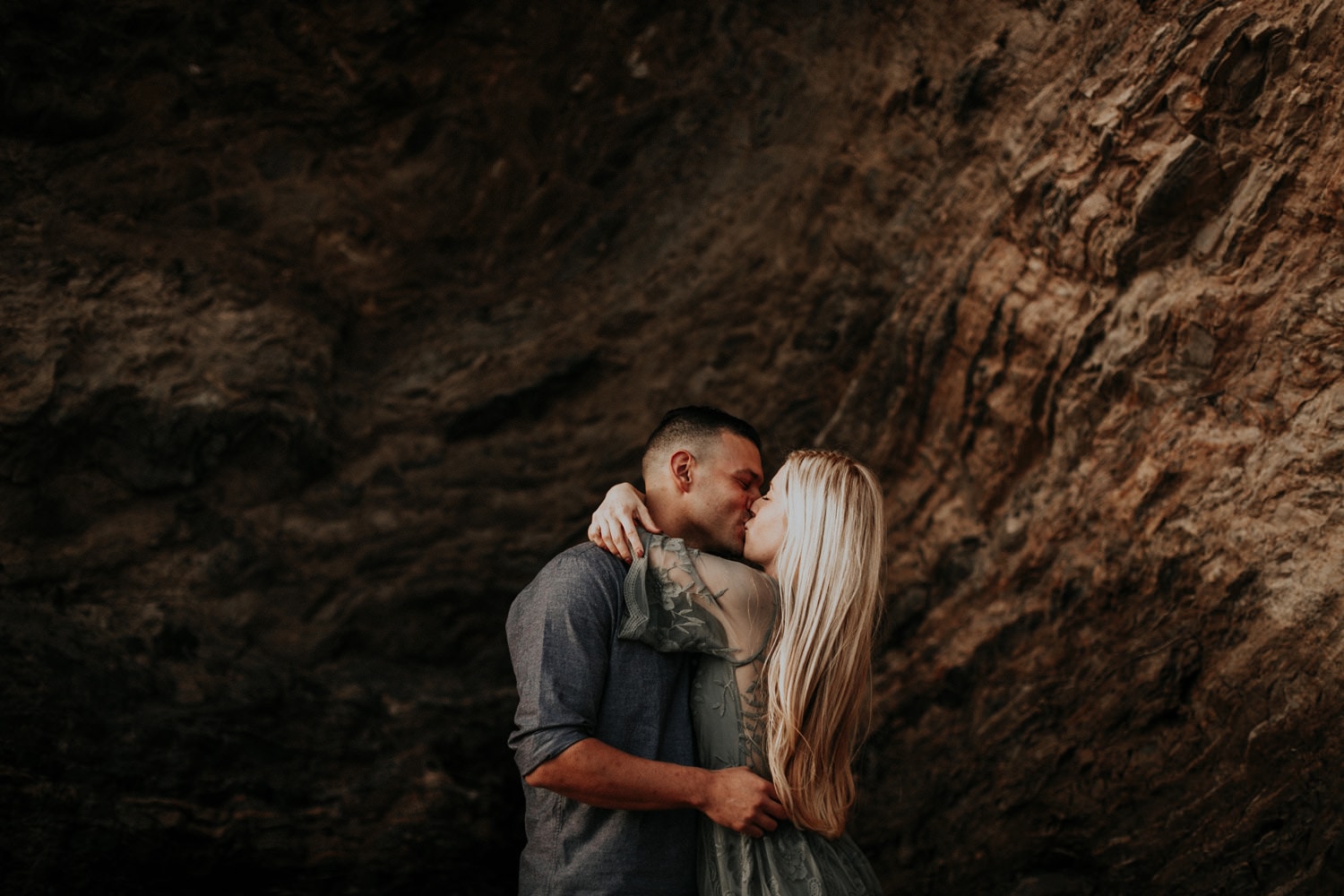 golden moody dark engaged couple kiss laguna beach engagement photographer