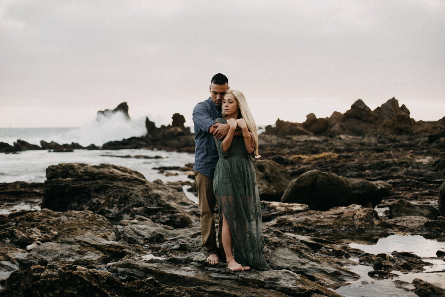 cute couple green gown sunset with waves crashing laguna beach engagement photographer