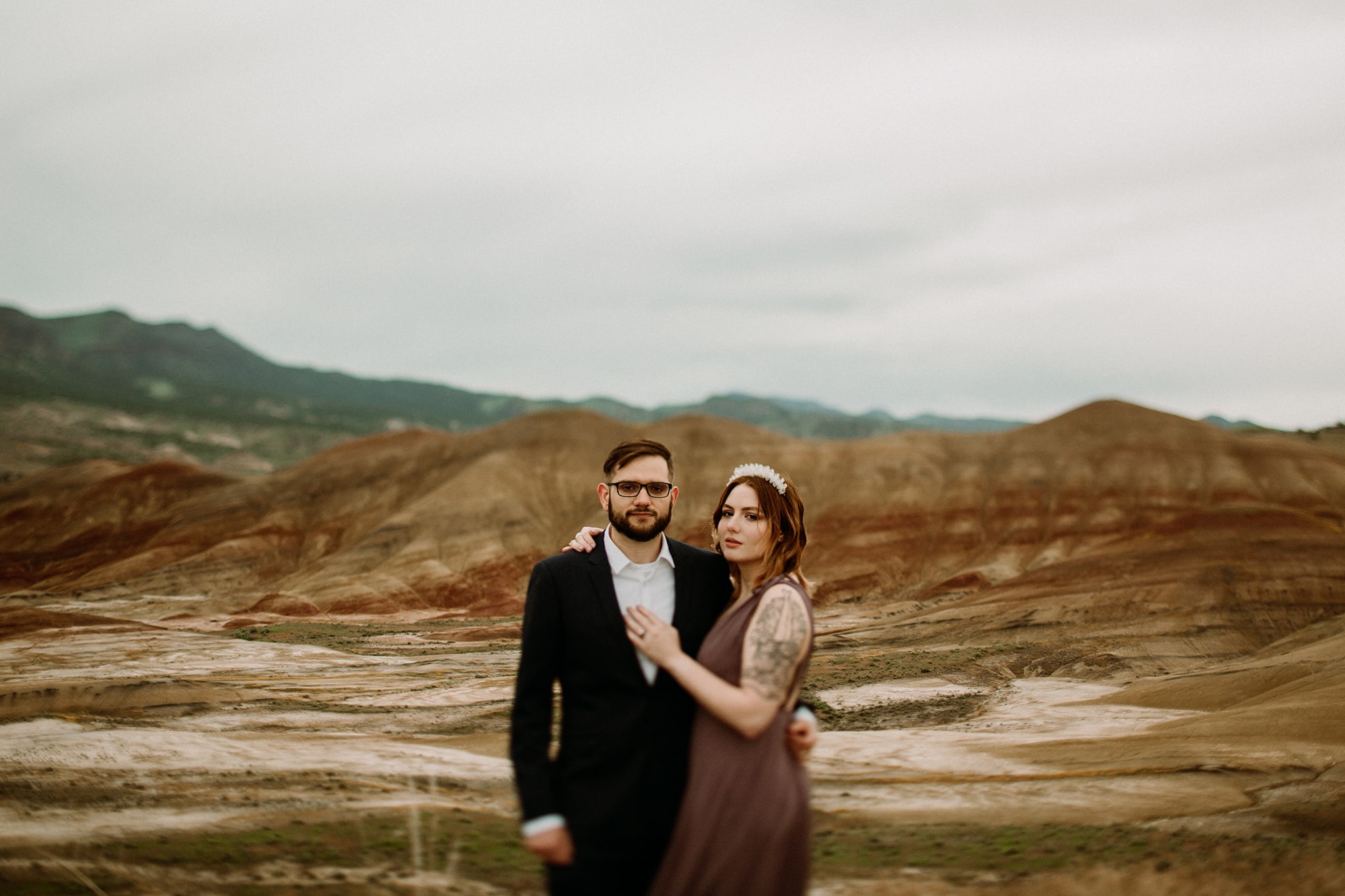 Bride and groom elope in Oregon at the Painted Hills wearing black and lavender dress by Lulus