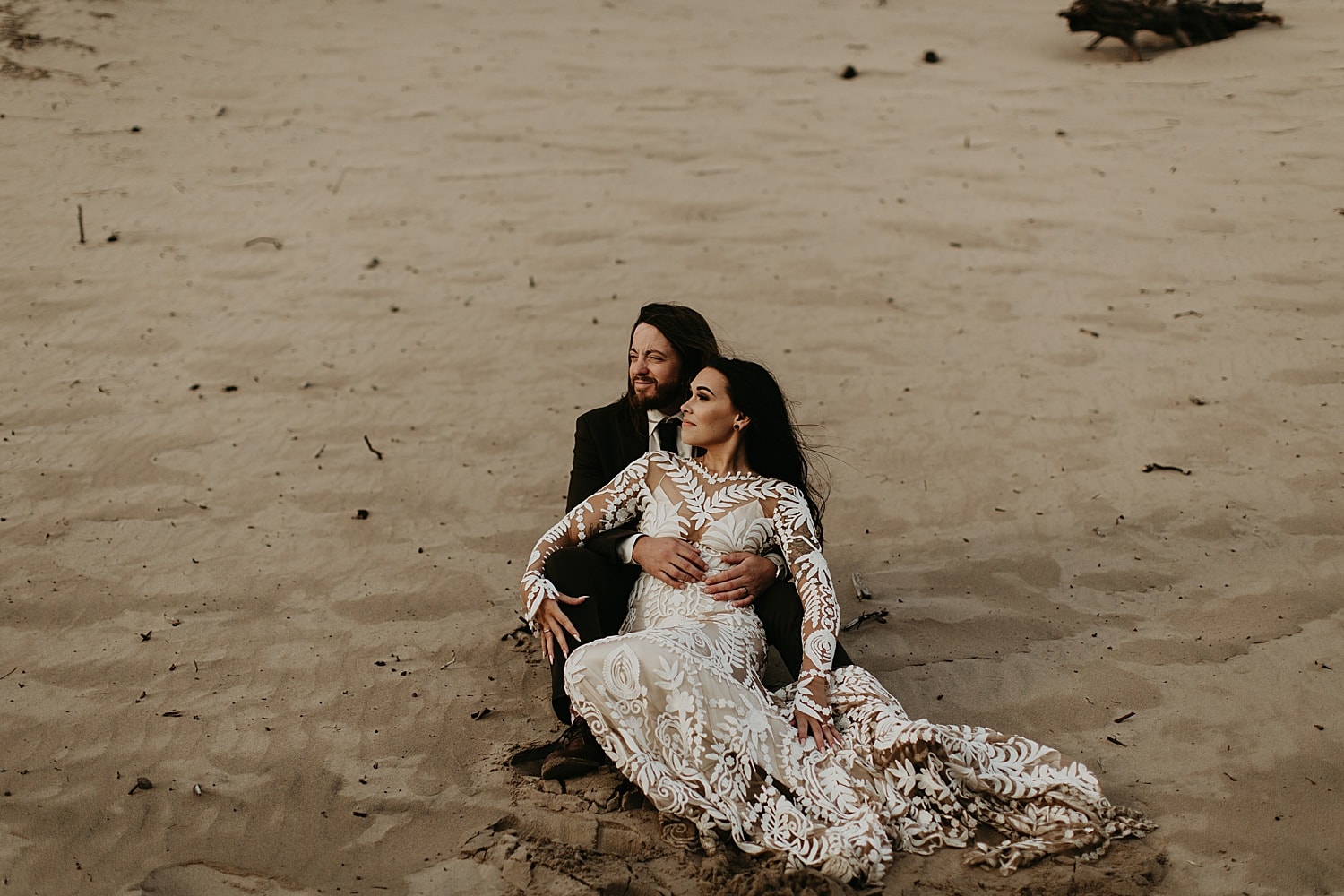 newlywed couple on a sand dune on the oregon coast cape kiwanda elopement by marcela pulido portland oregon wedding photography
