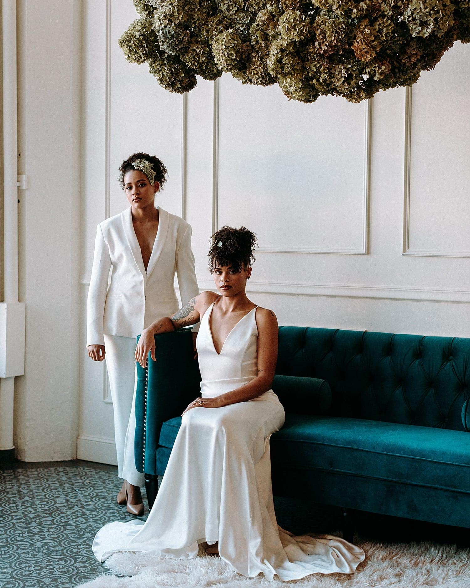 beautiful same sex lesbian lgbtq+ friendly wedding couple newlywed wearing all white gown and all white feminine suit