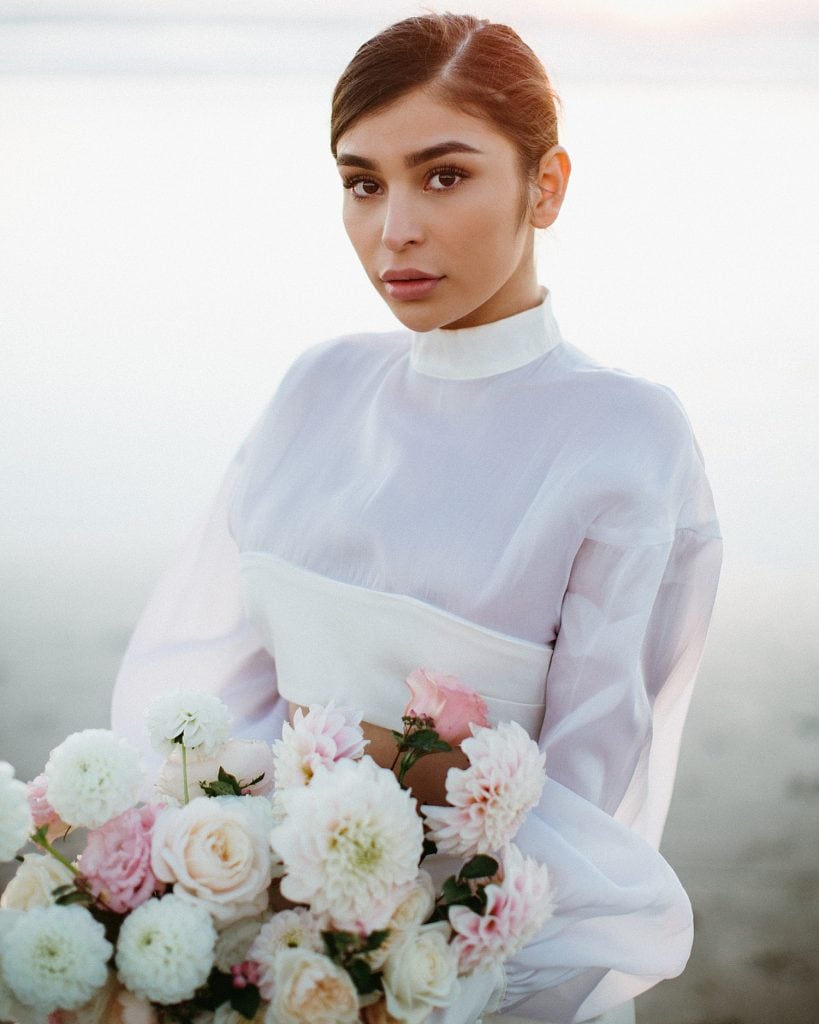 stunning gorgeous latina bride in luxury two piece wedding gown at cannon beach elopement with novella theory wedding bouquet captured by marcela pulido portland oregon wedding photographer